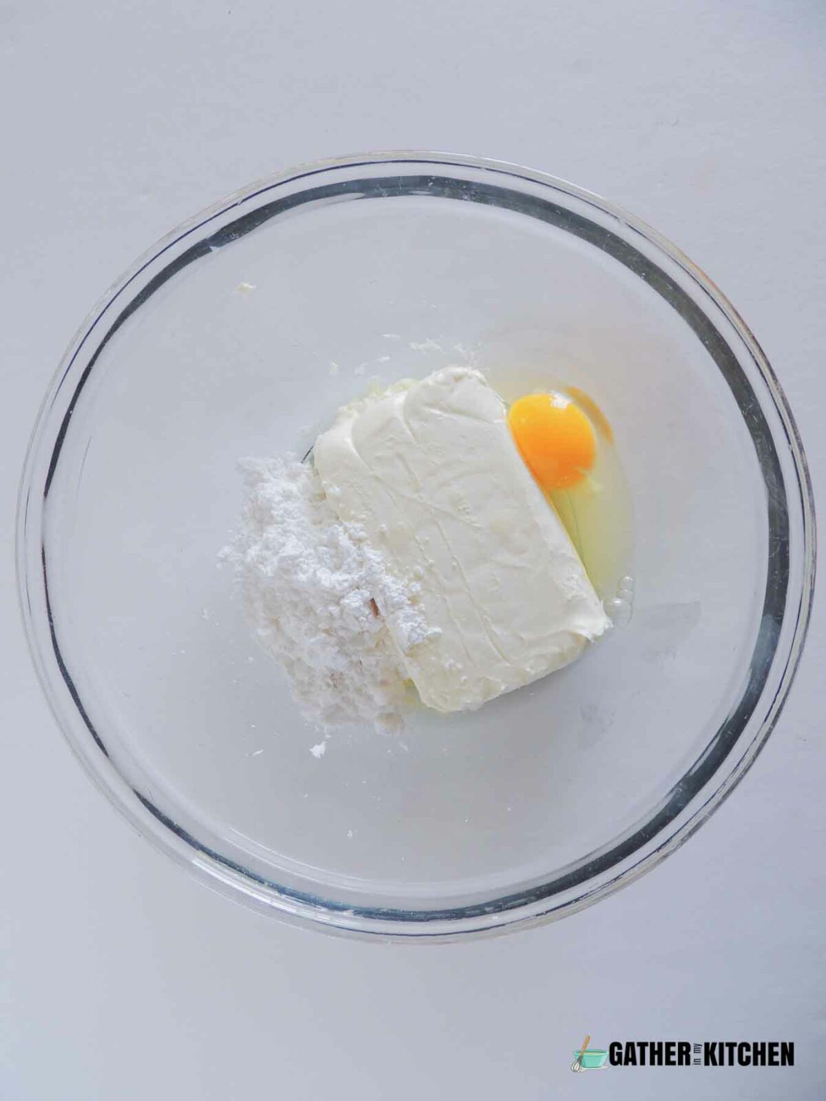 eggs, cream cheese and sugar in a bowl.