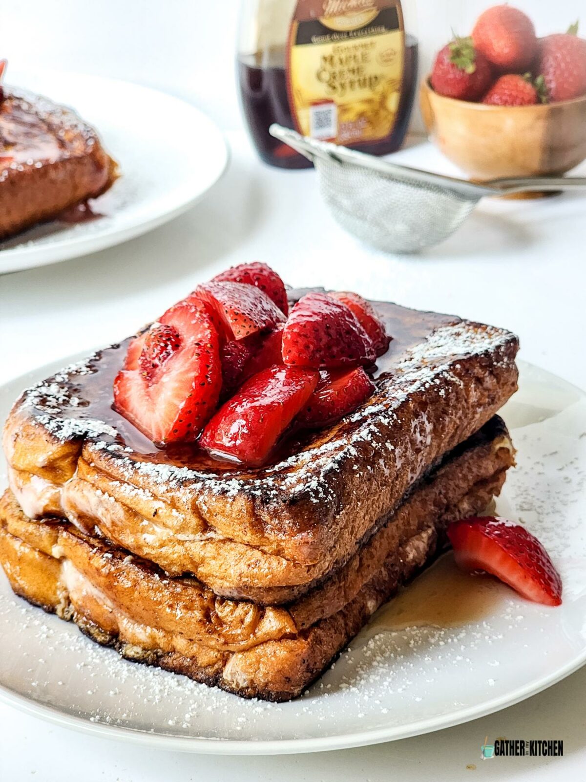 Strawberry Cheesecake French Toast stacked on a plate.