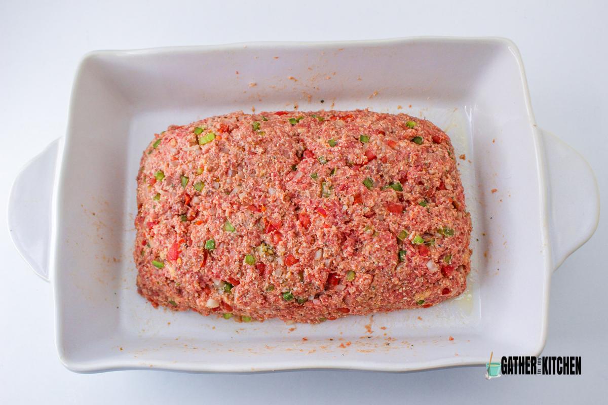 Raw meatloaf in a dish.