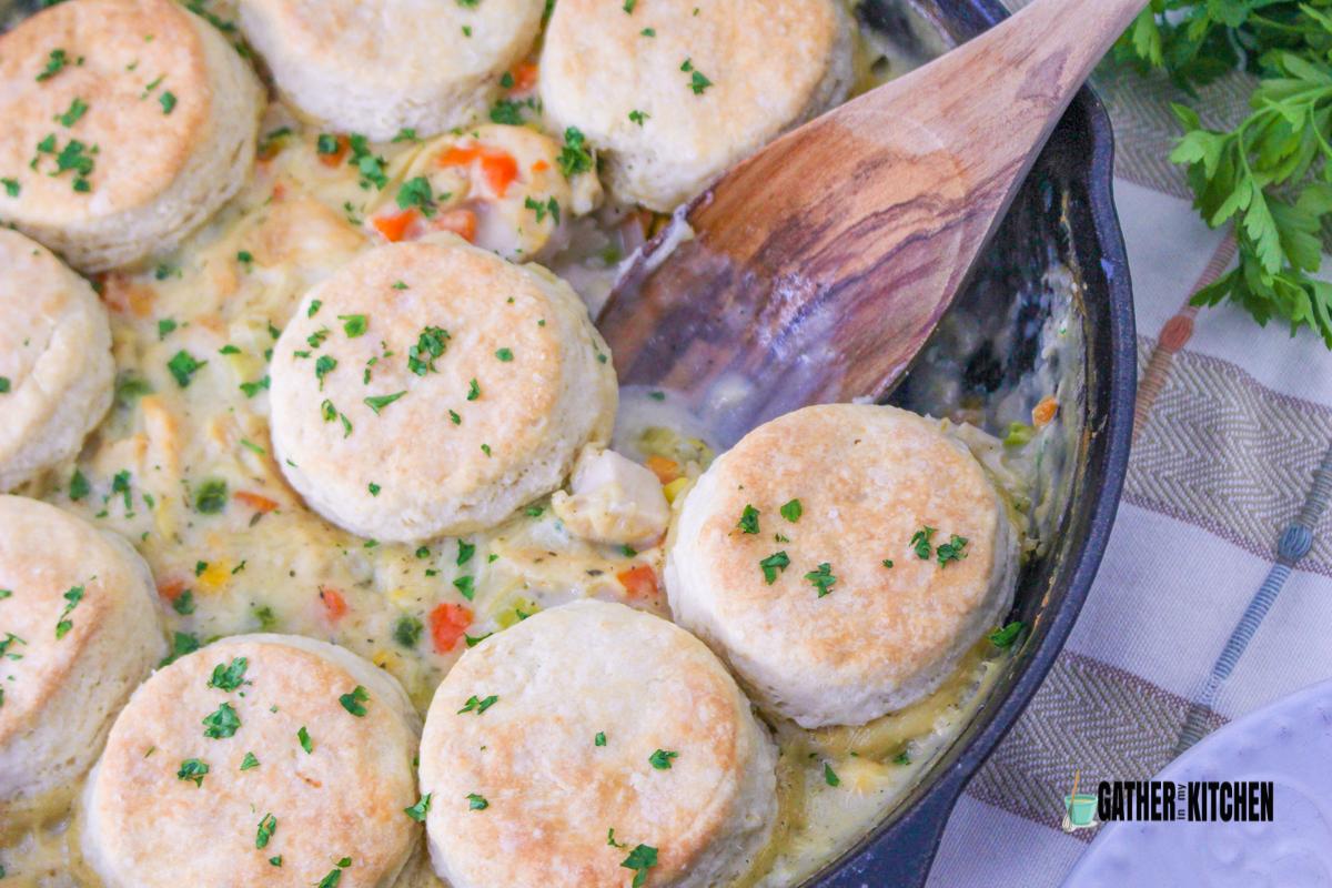 Cooked biscuits over filling on skillet.