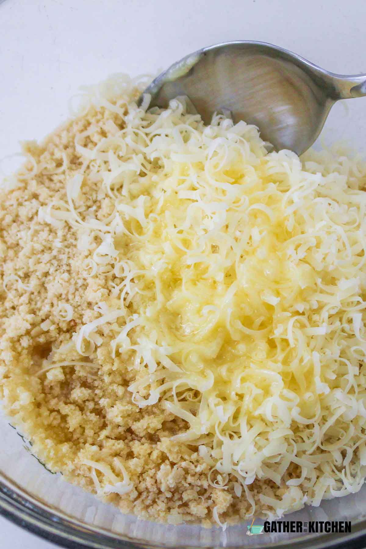 Breadcrumbs, Parmesan and melted butter in a bowl.