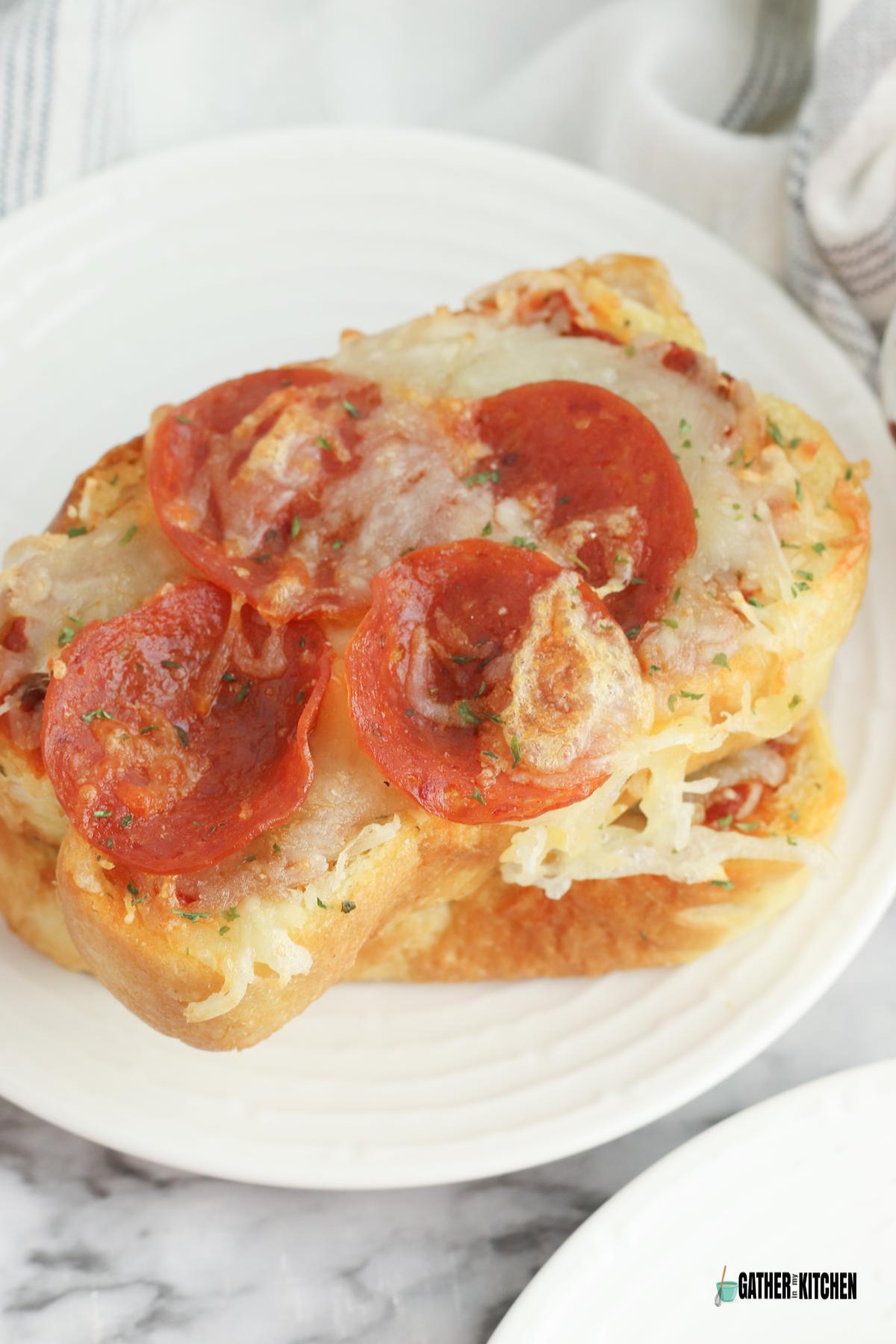 Garlic toast pizza on a plate.