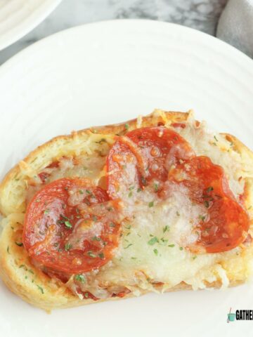 Garlic toast pizza on a plate.