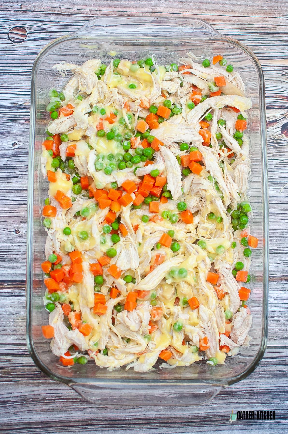 Casserole dish with the veggies, chicken, and cream of chicken soup in it.