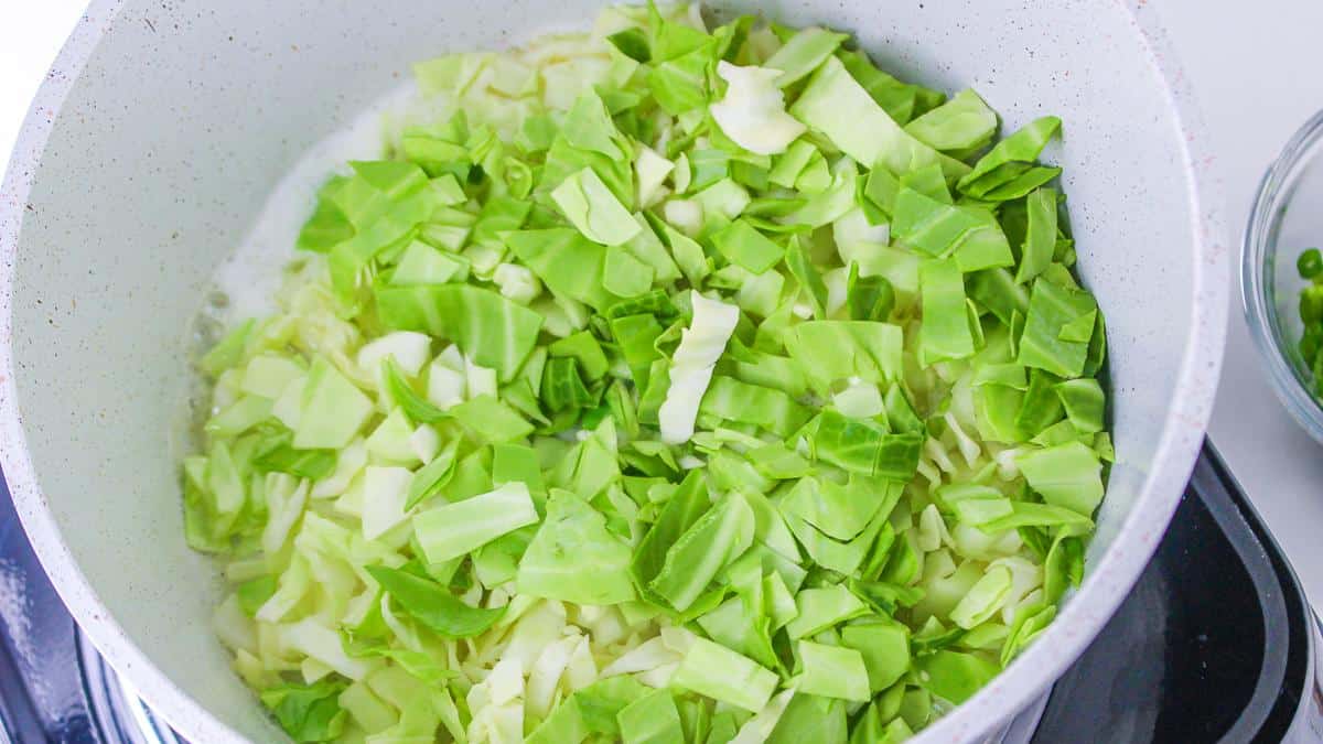 Cabbage cooking in pan.