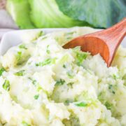 Colcannon Potatoes in a dish with a serving spoon.