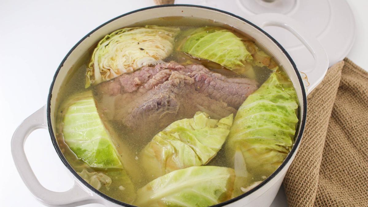 Cabbage on top of corned beef in Dutch oven.