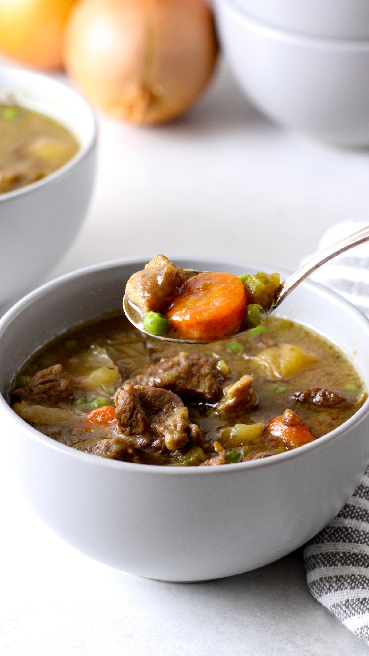 Irish stew being lifted on a spoon.