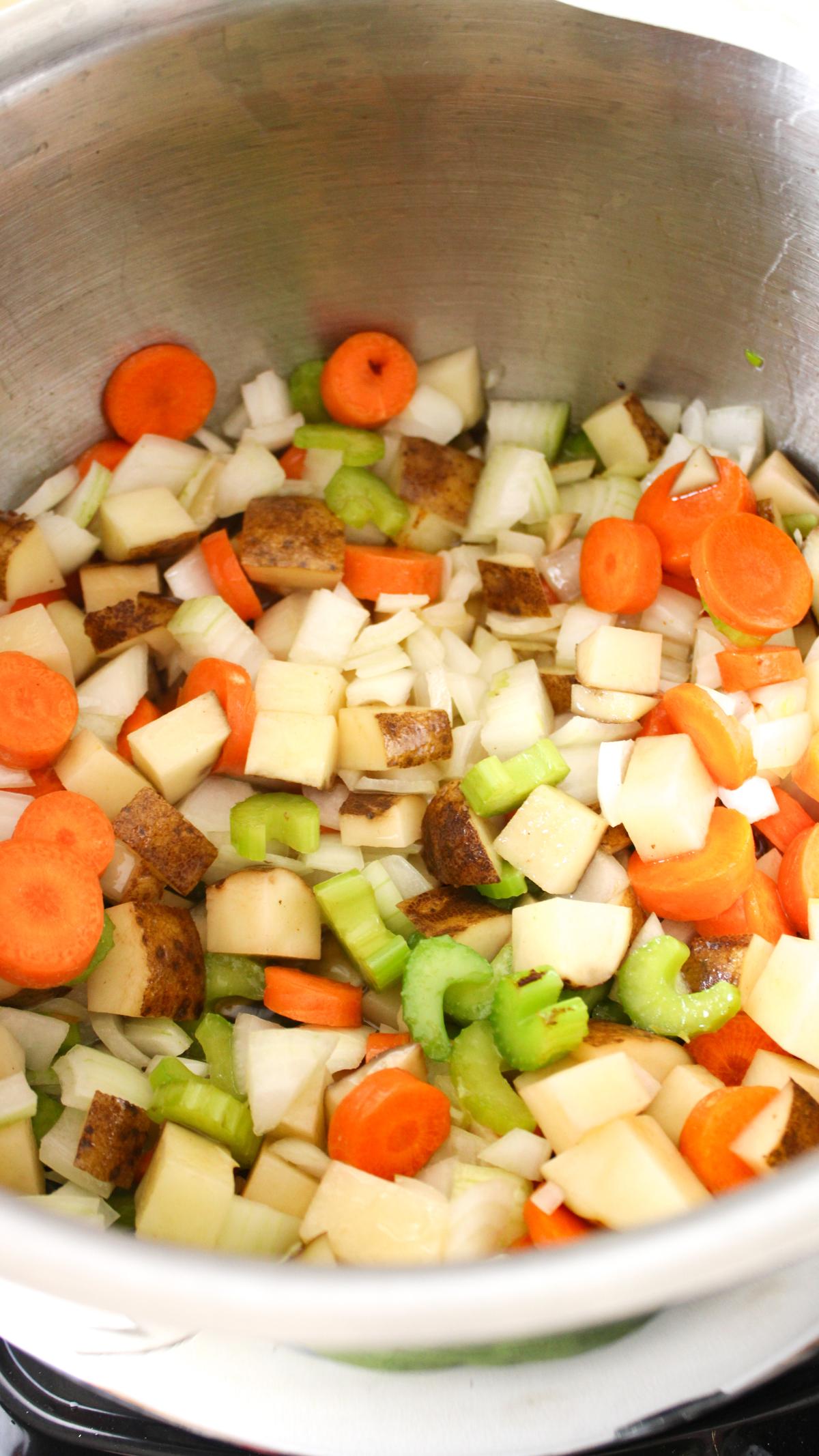 Veggies added to stock pot to cook.