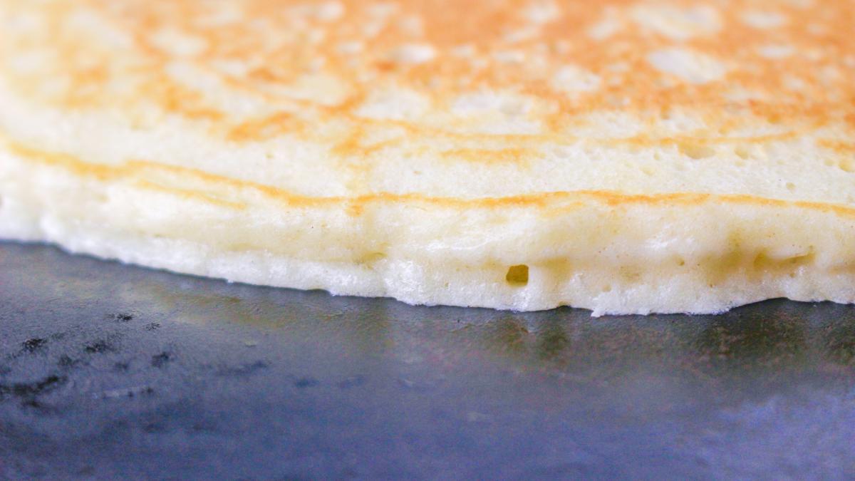 Flipped pancake on a griddle.