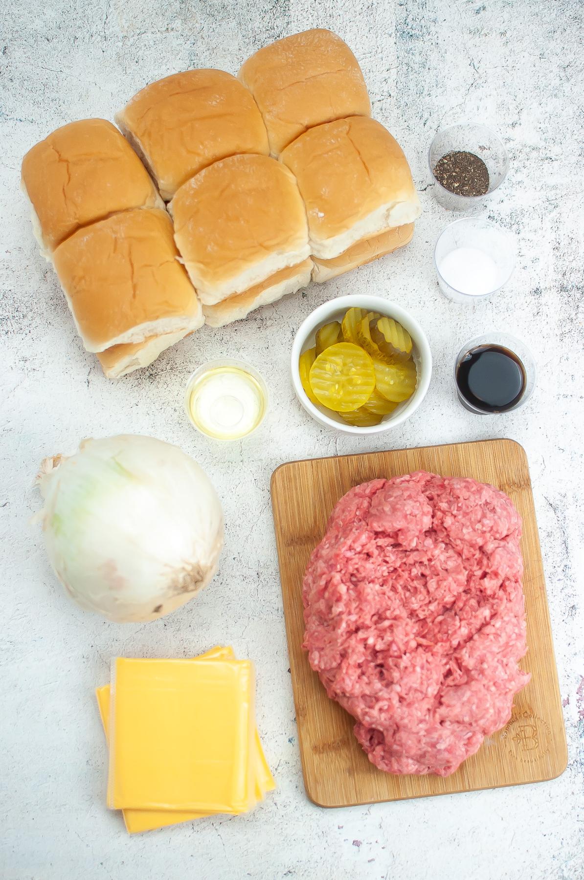 Ingredients for white castle burgers: slider buns, pepper, salt, Worcestershire sauce,  pickles, oil, ground beef, American cheese, and an onion.