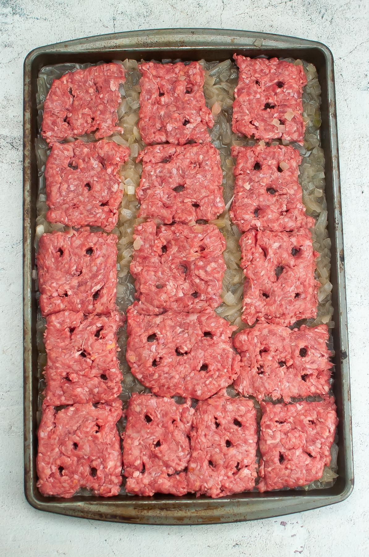 Hamburger patties on shallow sheet pan.