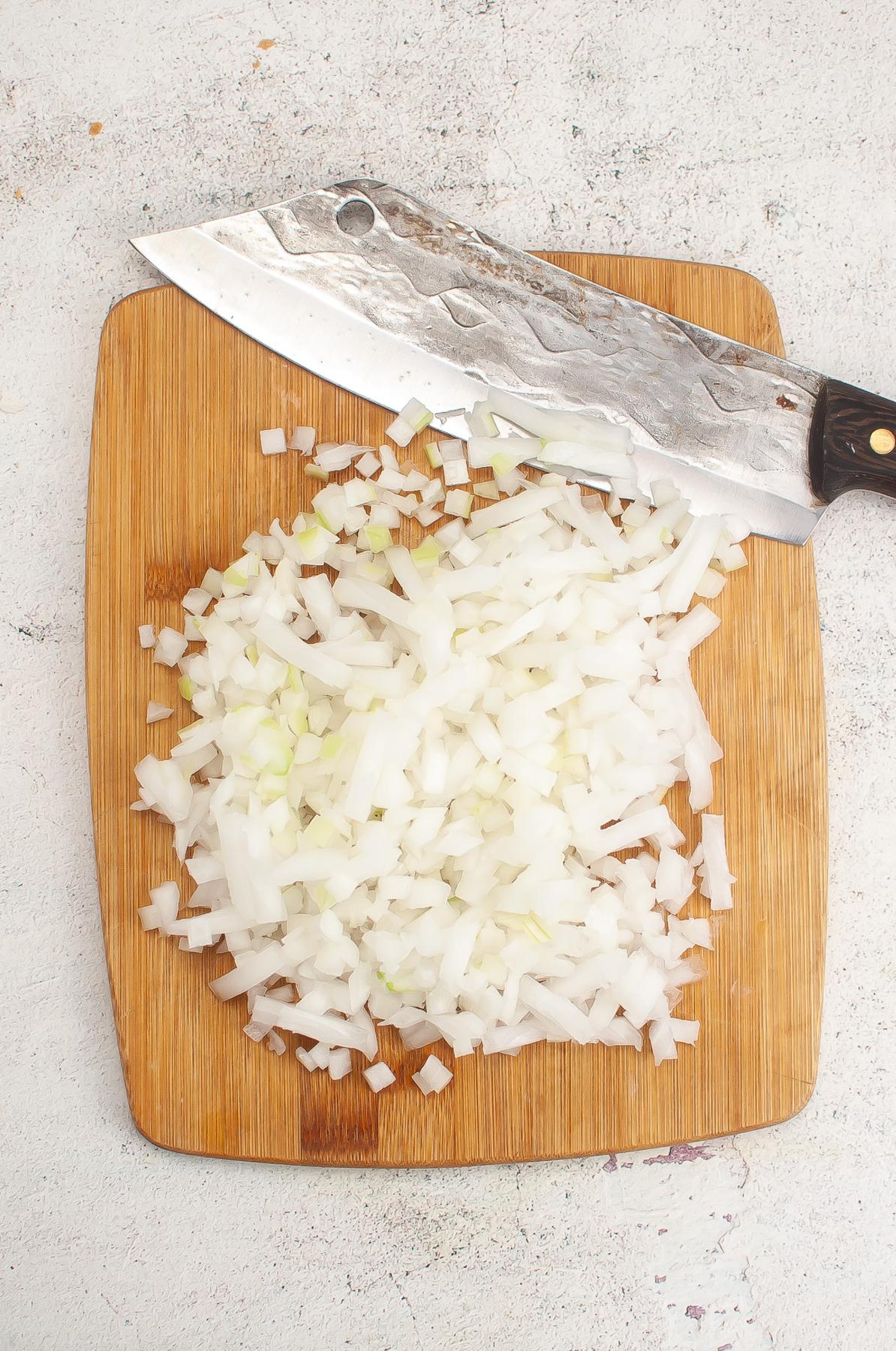 Onions diced small on a cutting board.