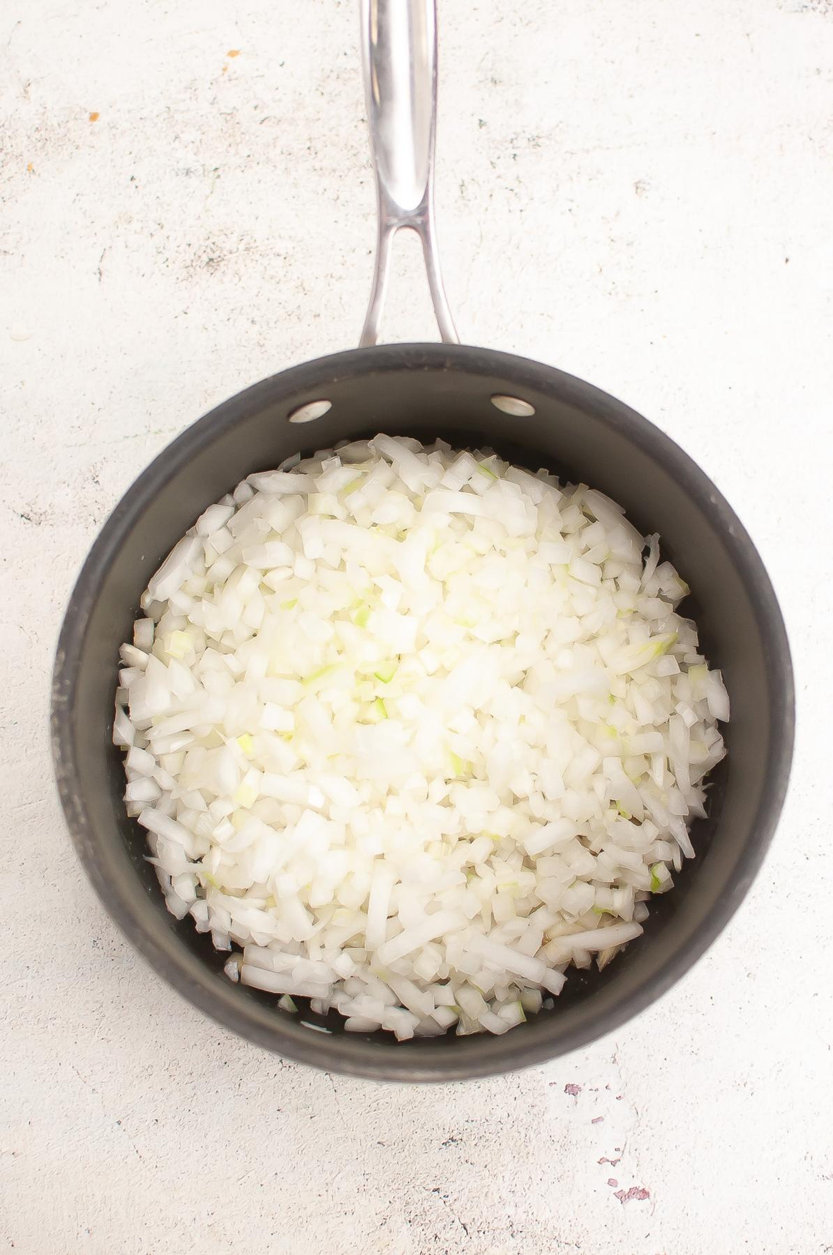 Diced onion is saucepan.