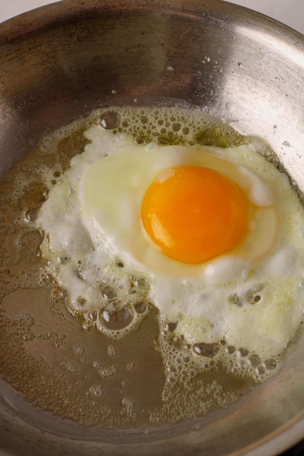 Egg in a pan cooking.