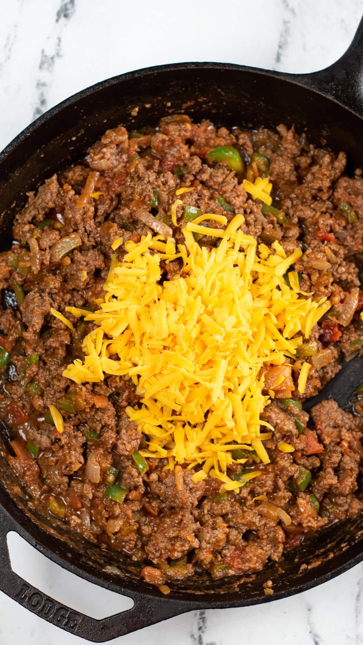 Shredded cheese added to meat mixture.