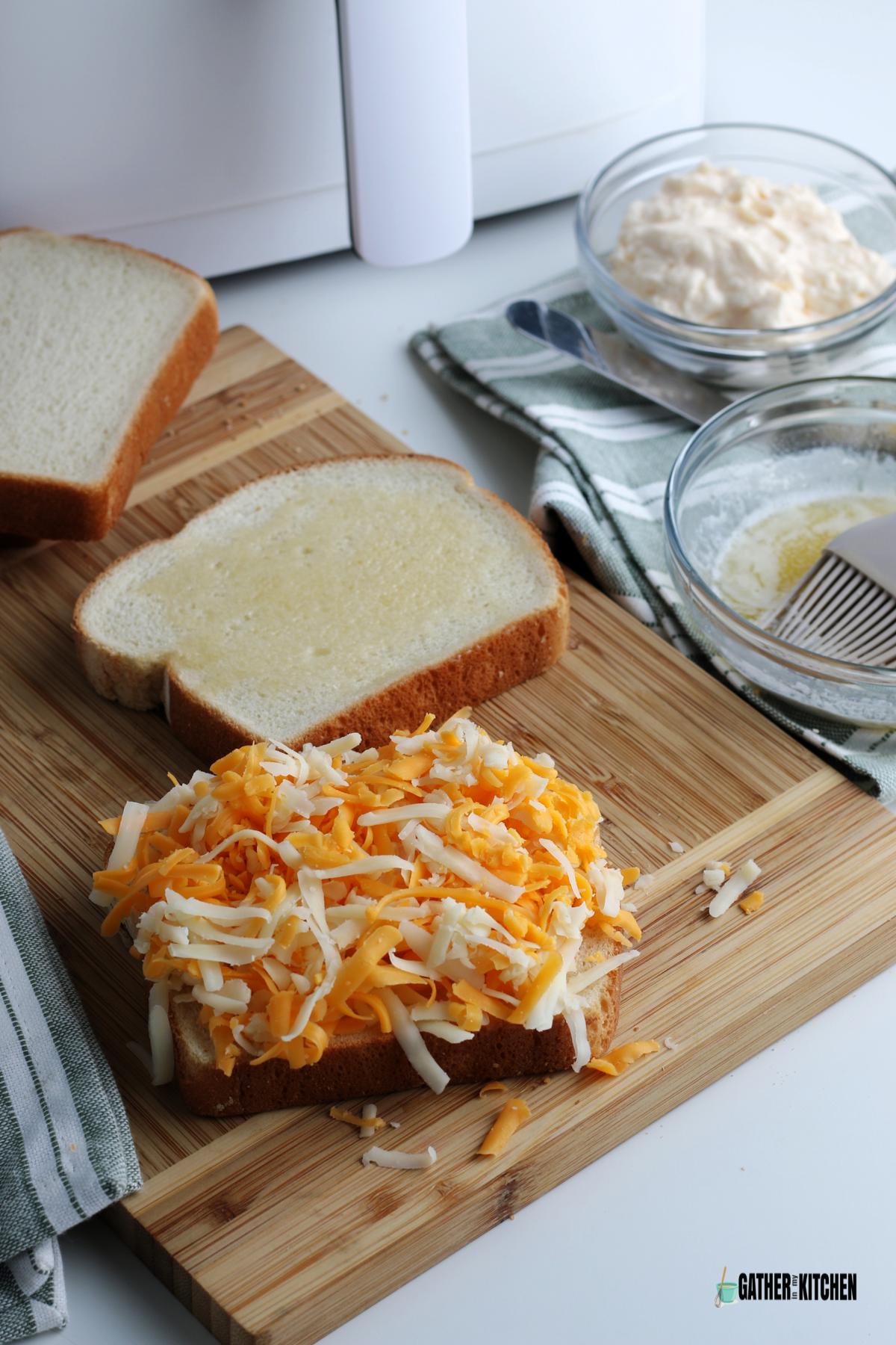 Grated cheese piled high on one slice of bread.
