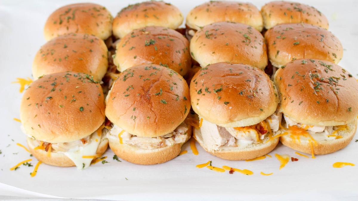 Cooked chicken bacon ranch sliders on parchment paper.