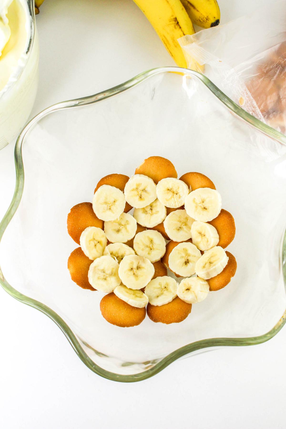 Top down view of sliced bananas in bowl.