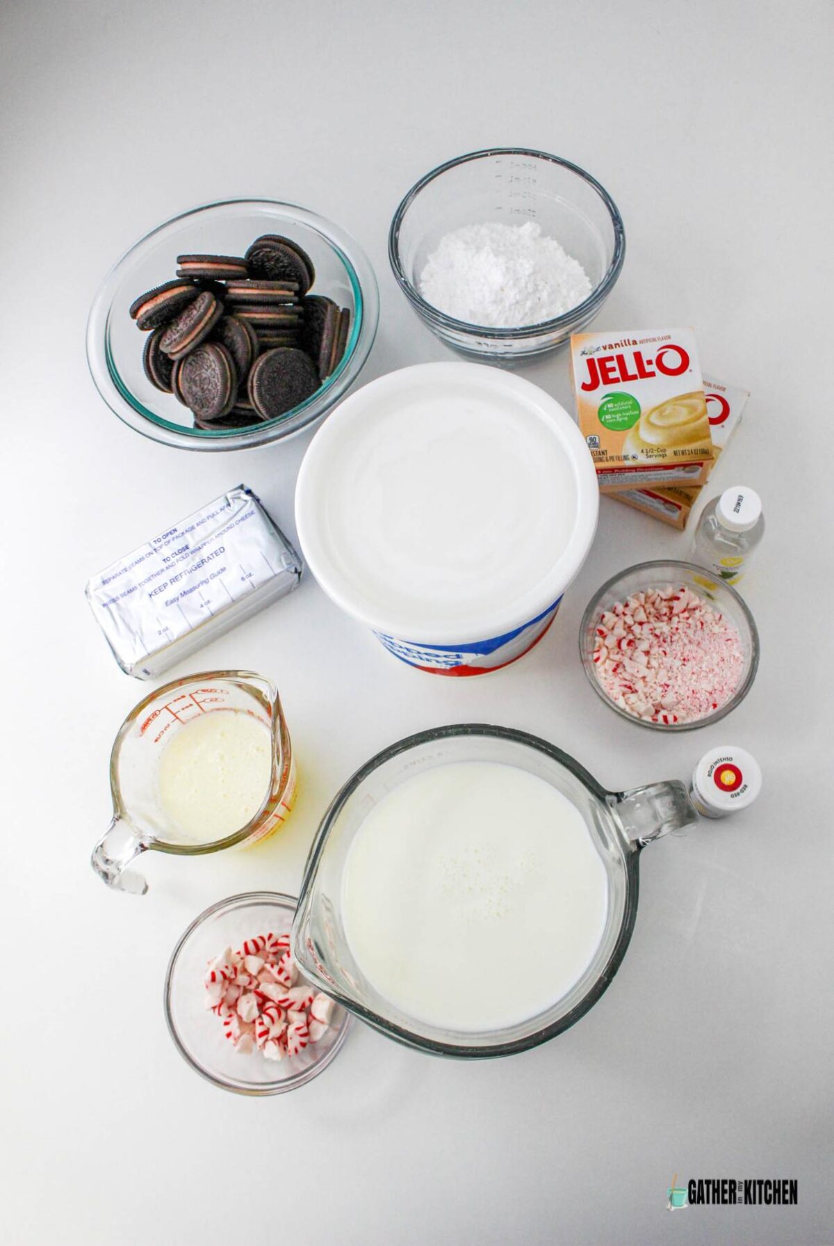 Ingredient for candy cane lush: Oreos, powdered sugar, whipped topping, boxes of Instant vanilla pudding, peppermint extract, crushed peppermint candy, red food dye, milk, peppermint candies,  melted butter, and cream cheese.